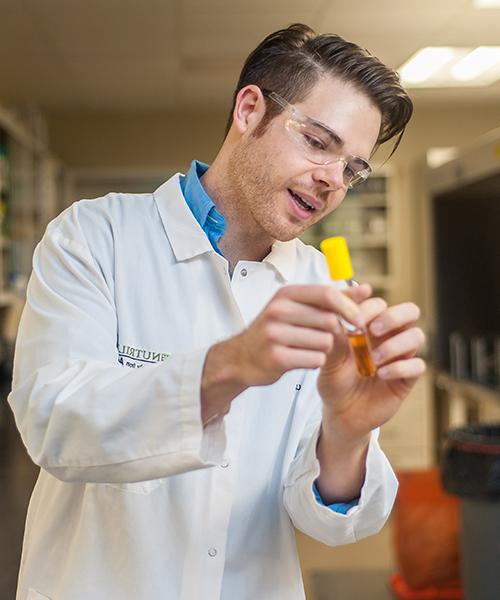 alumni holding test tube